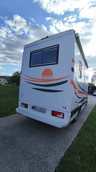 Sunset vinyl graphic on the back of a camper van