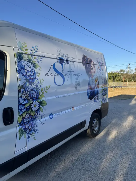Branded van with floral motifs and an illustration